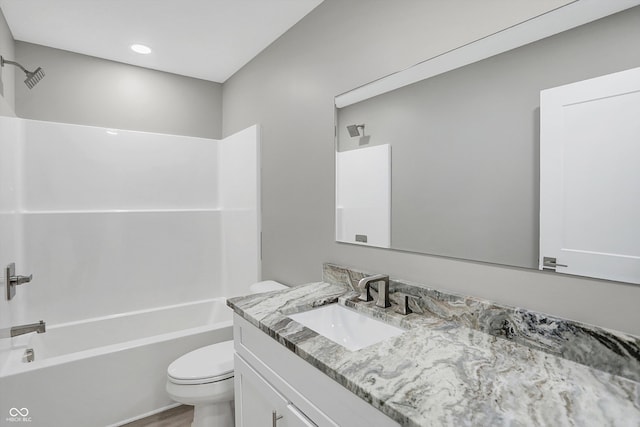 full bathroom featuring vanity, toilet, bathtub / shower combination, and hardwood / wood-style flooring