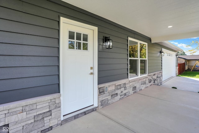 view of exterior entry with a garage