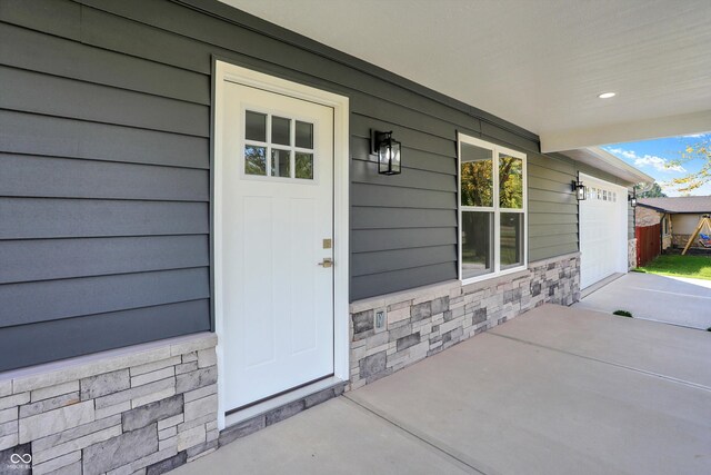 7234 N Christopher Ln, Fairland, IN 46126 - doorway to property with stone siding and a garage