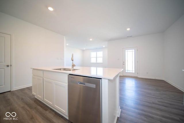 kitchen featuring stainless steel dishwasher, dark wood-type flooring, sink, white cabinetry, and an island with sink