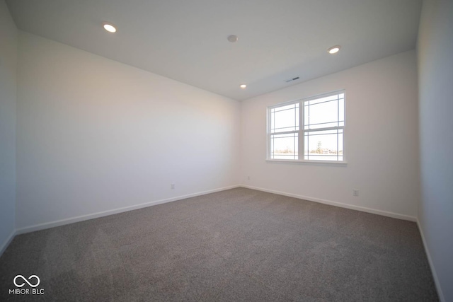 empty room featuring dark carpet