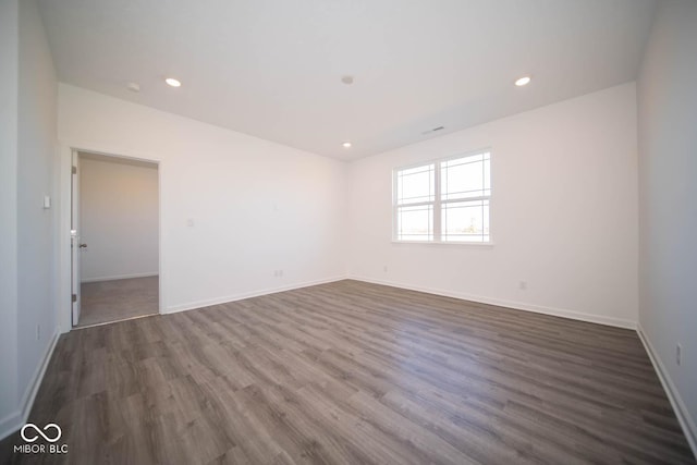 unfurnished room with dark hardwood / wood-style flooring