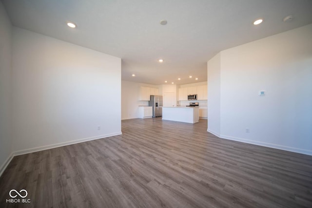 unfurnished living room featuring dark hardwood / wood-style floors