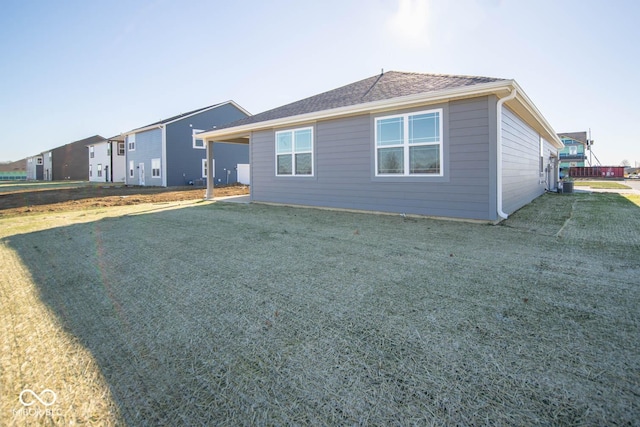 view of side of home featuring a lawn