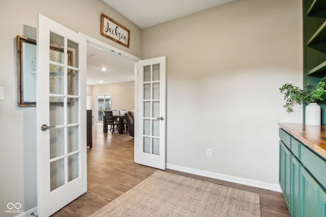 interior space featuring french doors and light hardwood / wood-style floors