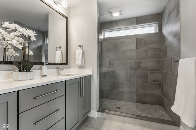 bathroom featuring a tile shower and vanity