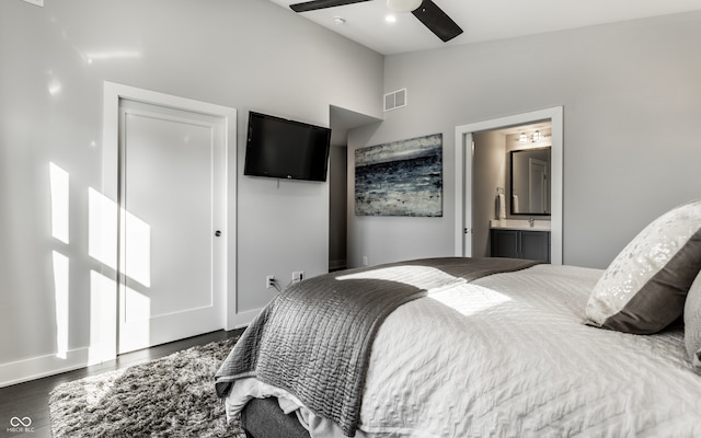 bedroom with high vaulted ceiling, ceiling fan, connected bathroom, and dark hardwood / wood-style flooring