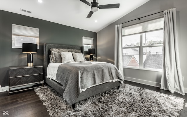 bedroom featuring ceiling fan, vaulted ceiling, and multiple windows