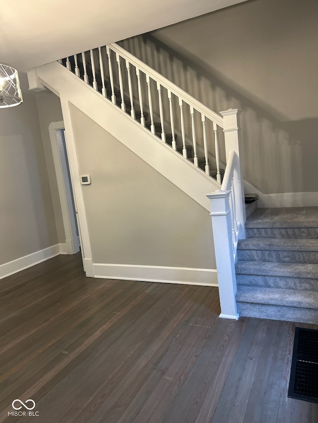 stairway featuring wood-type flooring