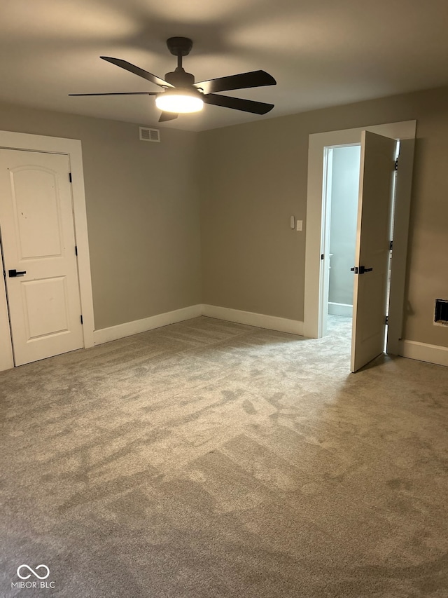 carpeted empty room with ceiling fan