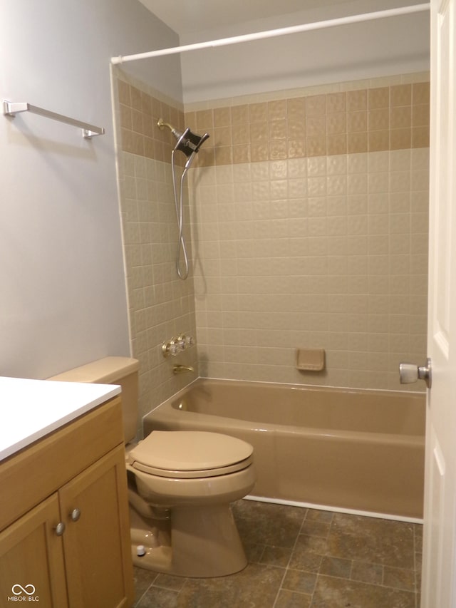 full bathroom featuring vanity, toilet, and tiled shower / bath combo