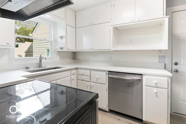 kitchen with sink, black stove, stainless steel dishwasher, white cabinets, and light hardwood / wood-style flooring