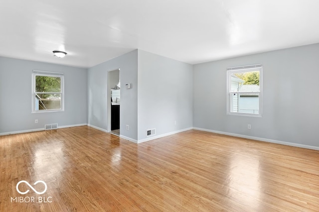 unfurnished living room with light hardwood / wood-style flooring and a wealth of natural light