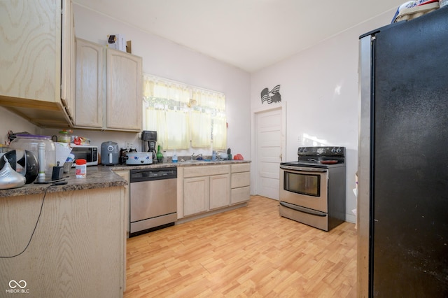 52 Home Ave, Terre Haute, IN 47803 - kitchen featuring stainless steel appliances, light wood-type flooring, and light brown cabinets
