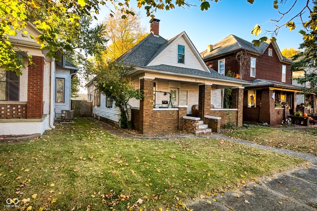 52 Home Ave, Terre Haute, IN 47803 - view of front of house featuring brick siding, covered porch, and a chimney