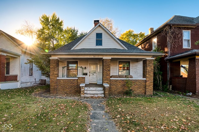 52 Home Ave, Terre Haute, IN 47803 - bungalow-style home with brick siding, a front yard, roof with shingles, and covered porch