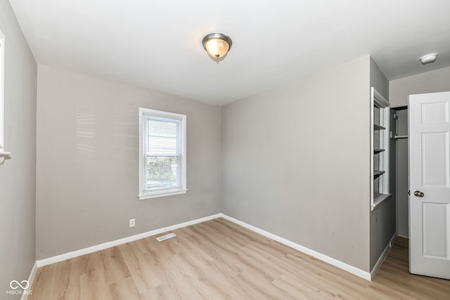 unfurnished room with light hardwood / wood-style flooring