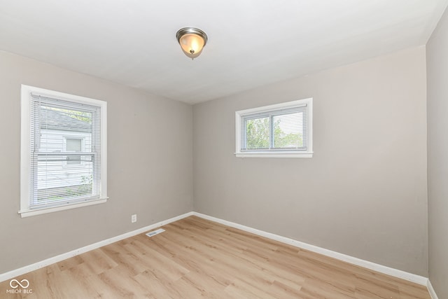 unfurnished room with a healthy amount of sunlight and light wood-type flooring