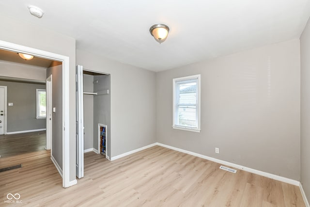 unfurnished bedroom featuring a closet and light wood-type flooring