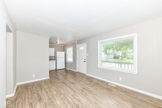 unfurnished living room featuring light hardwood / wood-style floors