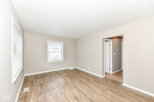 unfurnished room with light wood-type flooring