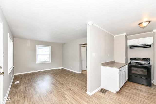 kitchen featuring black electric range oven, white cabinets, and light hardwood / wood-style flooring