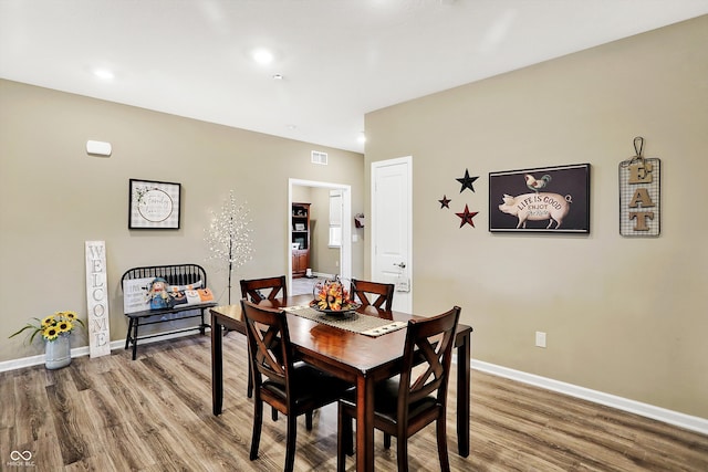 dining space featuring hardwood / wood-style floors