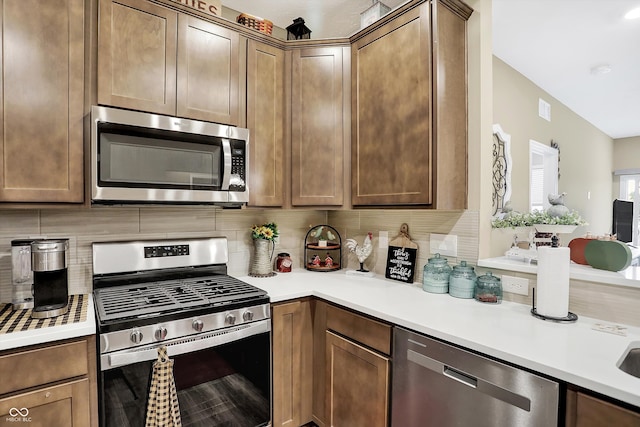 kitchen featuring stainless steel appliances and decorative backsplash