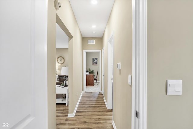 hall with hardwood / wood-style flooring