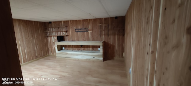 interior space with wooden walls and light wood-type flooring