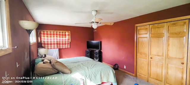 carpeted bedroom featuring a closet and ceiling fan