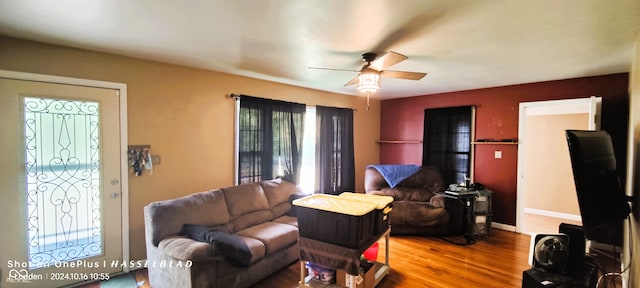 living room featuring ceiling fan and hardwood / wood-style floors