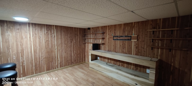 view of sauna / steam room with hardwood / wood-style flooring and wood walls