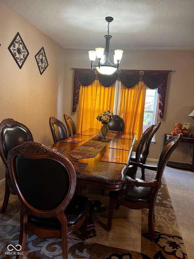 dining space with carpet floors, a notable chandelier, and a textured ceiling