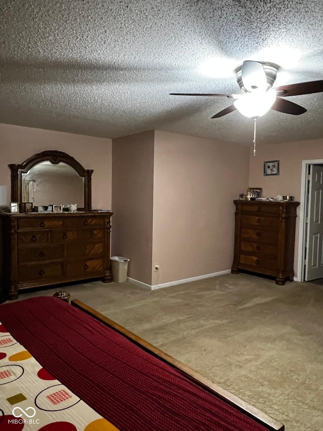 unfurnished bedroom with carpet flooring, ceiling fan, and a textured ceiling