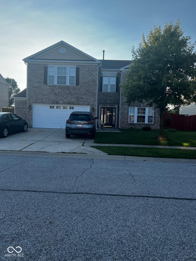 view of front of property with a front lawn and a garage