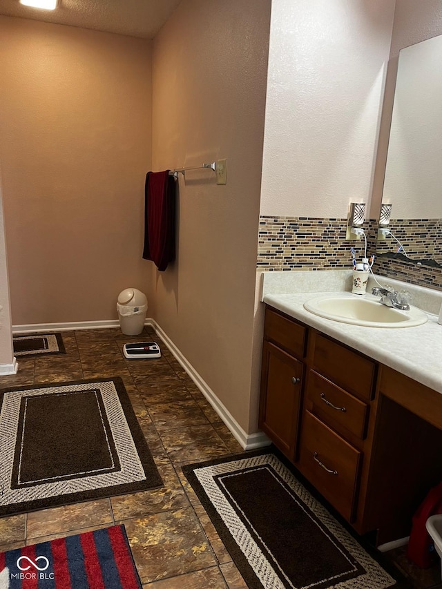 bathroom with vanity and backsplash