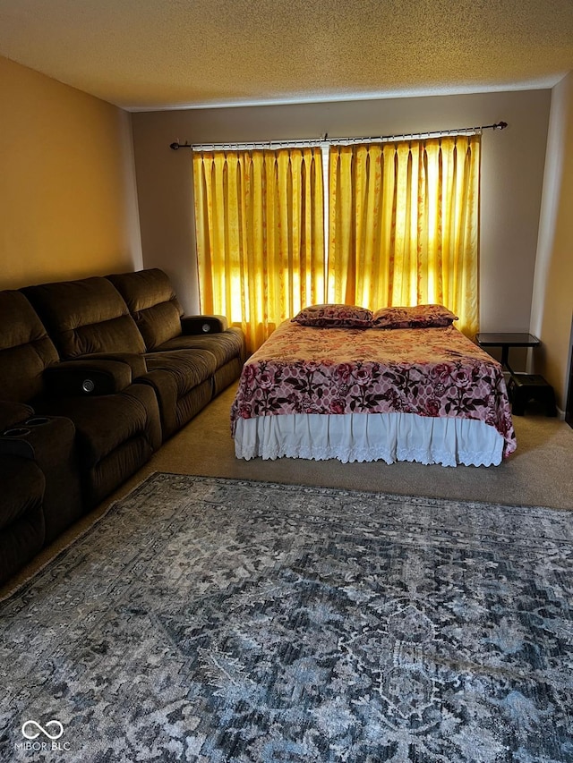 bedroom featuring carpet floors and a textured ceiling