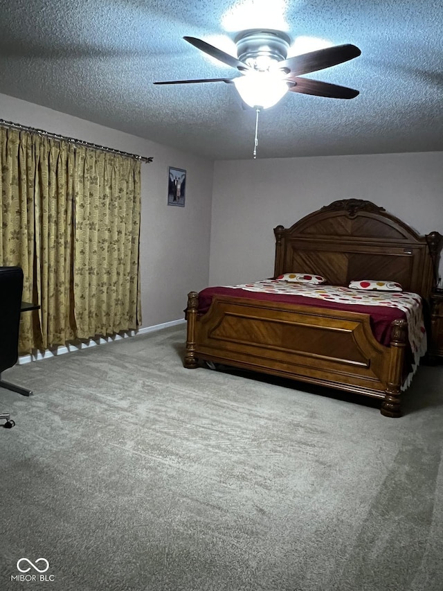 carpeted bedroom featuring ceiling fan and a textured ceiling