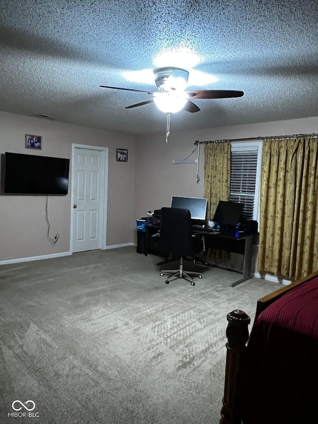 office featuring ceiling fan, carpet floors, and a textured ceiling