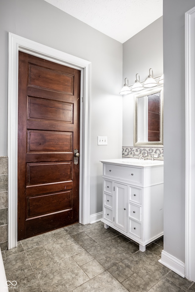 bathroom with vanity and a textured ceiling