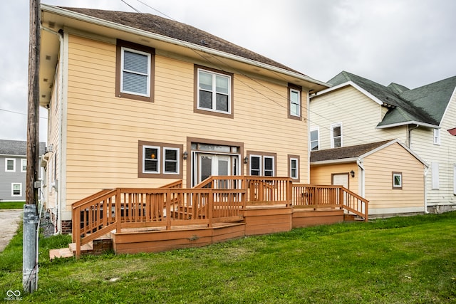 rear view of property with a yard and a wooden deck