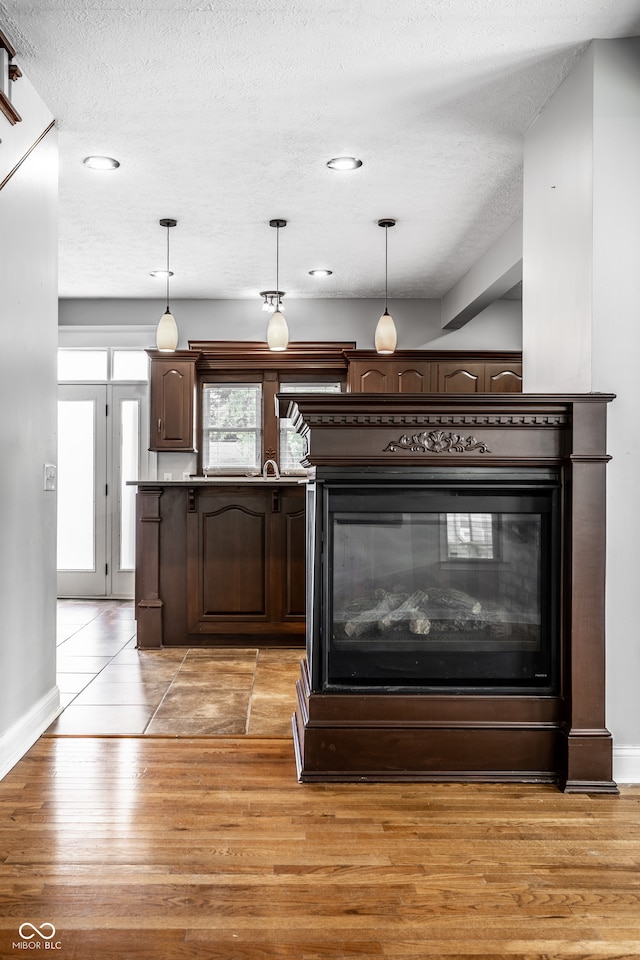 room details with a textured ceiling and hardwood / wood-style floors