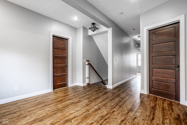 interior space with hardwood / wood-style floors and a textured ceiling