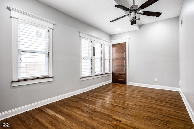 spare room with ceiling fan, a textured ceiling, and dark hardwood / wood-style floors