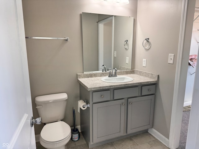 bathroom featuring tile patterned floors, vanity, and toilet