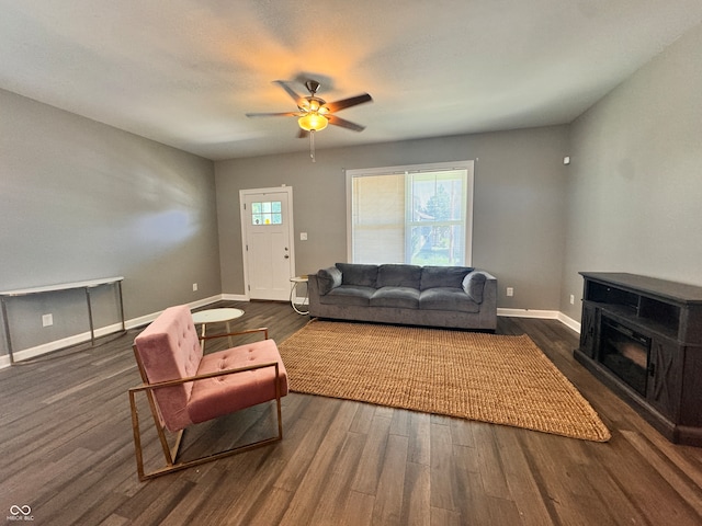 living room featuring ceiling fan and dark hardwood / wood-style floors