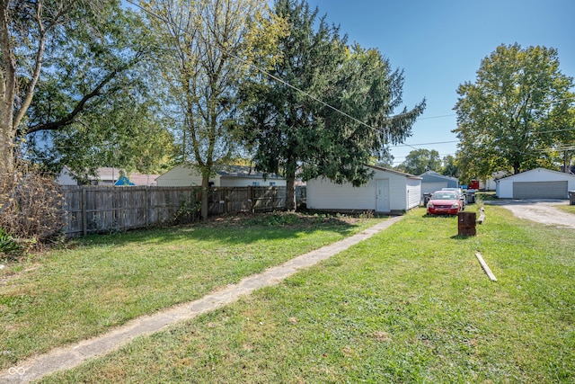 view of yard featuring a garage and an outdoor structure