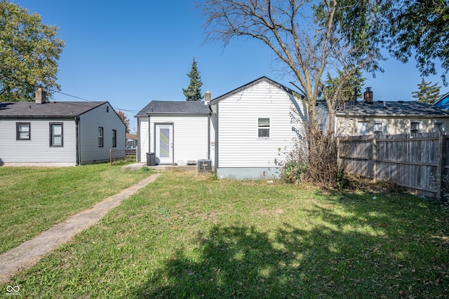 back of house with a lawn