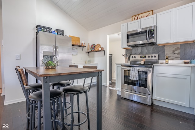 kitchen featuring wood ceiling, lofted ceiling, white cabinetry, appliances with stainless steel finishes, and dark hardwood / wood-style floors